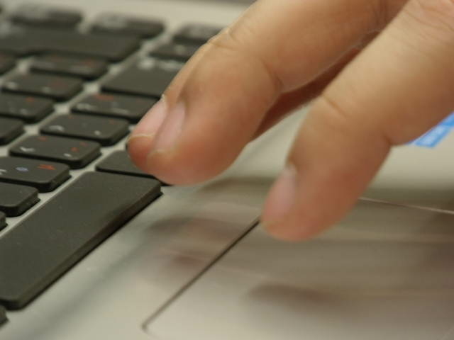 Hands typing on keyboard.